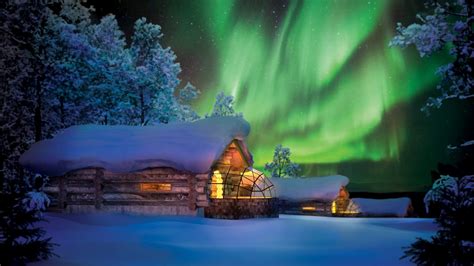 A kelo pine cabin with a glass igloo at Kakslauttanen offers the traditional chalet e ...