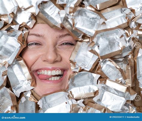 The Face of a Caucasian Woman Surrounded by Candy Wrappers. Girl Showing Tongue. Stock Image ...