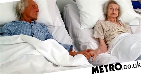 Elderly couple hold hands for last time after beds pushed together | Metro News