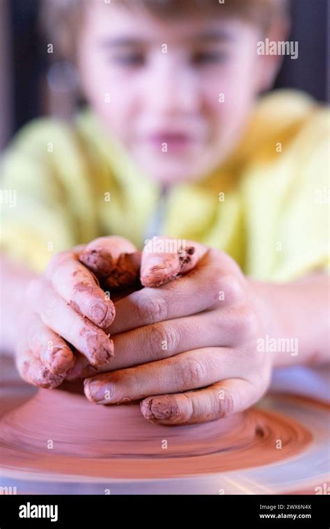 Boy making pottery wheel seen from close up Stock Photo - Alamy