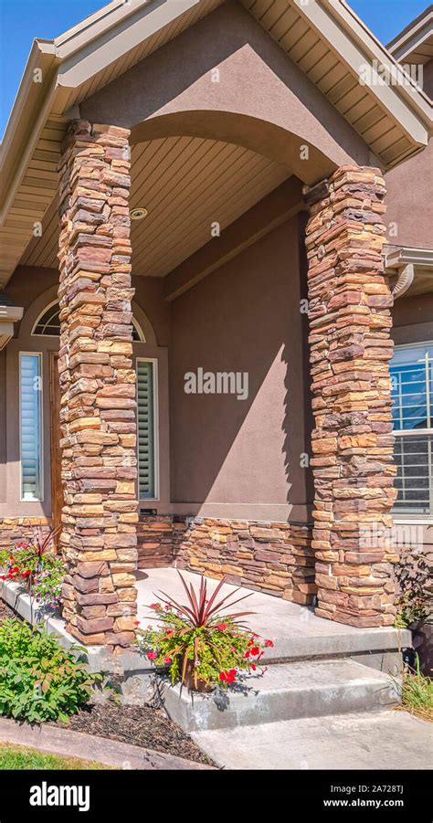 Vertical Modern house and front yard with stone pillars Stock Photo - Alamy