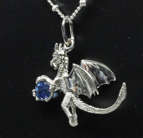 Sapphire dragon pendant, by George Postgate. In white gold.