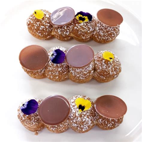 Earl Grey, bergamot & caramel éclair with milk chocolate decor and edible viola flowers # ...