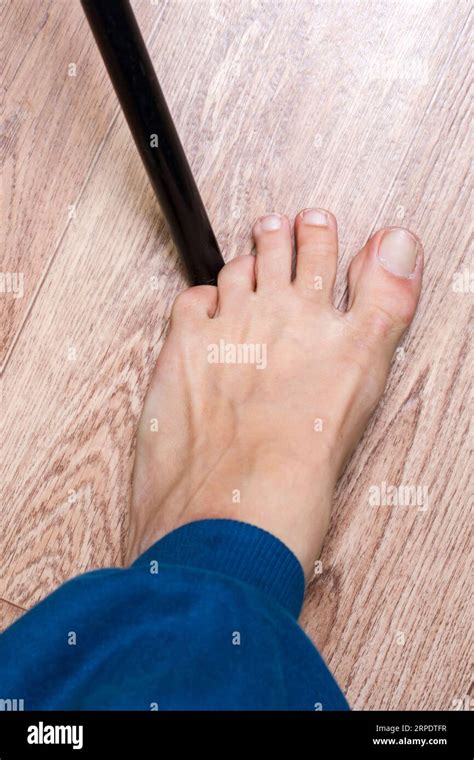 Kicking a toe on a chair leg close up Stock Photo - Alamy