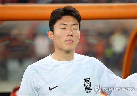 Hwang Ui-jo of South Korean stands on the sidelines for the national anthem before the start of ...