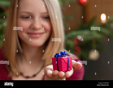 girl with small christmas present Stock Photo - Alamy