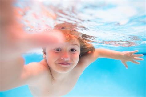 Premium Photo | Underwater boy in the swimming pool cute kid boy swimming in pool under water