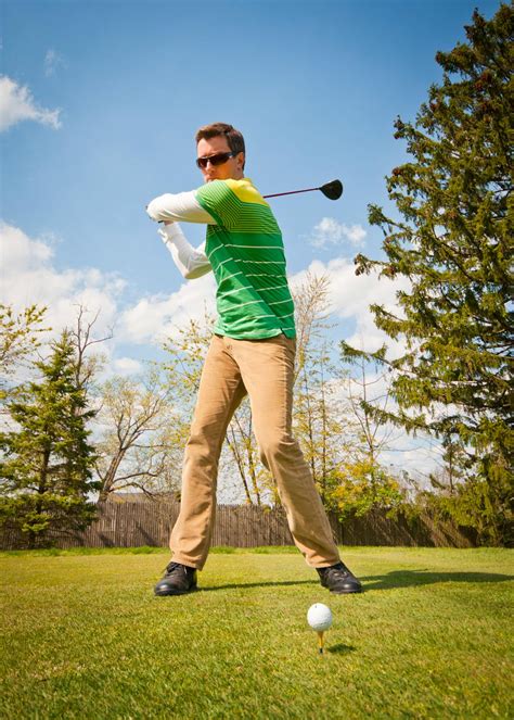 Man in Green and White Stripes Long Sleeve Shirt Holding Black Golf ...