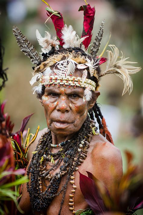 Old Papua woman wearing shells and feathers as decoration. | Papua new guinea, World cultures, Papua