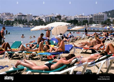 People sunbathing on the beach in San Antonio, Ibiza, Spain Stock Photo - Alamy