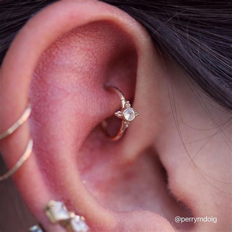 Healed rook piercing upgrade featuring a white sapphire in gold "Mini Kandy" ring, from @bvla ...