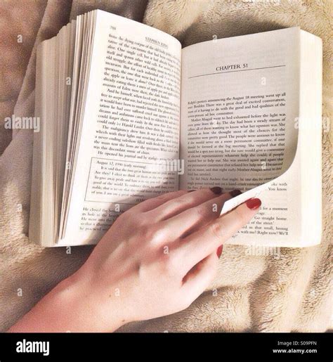 Book with hand turning a page Stock Photo - Alamy