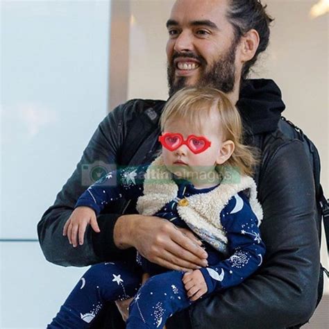 Russell Brand spotted arriving at Heathrow Airport in London with his 15-month-old daughter # ...