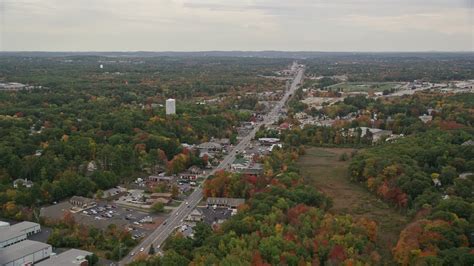 5.5K stock footage aerial video flying by shops, Broadway, colorful trees, autumn, overcast ...