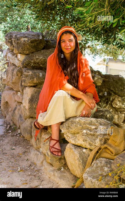 A young woman in period costume in the open air museum of Nazareth Village Israel. This site ...