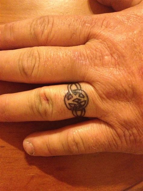 Pin by Brittany Norton on Tattoos | Tattoo wedding rings, Wedding ring tattoo for men, Ring tattoos