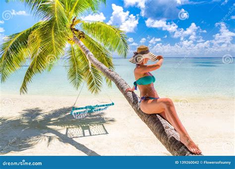 Woman in Hot Sunny Weather Laying Down on a Palm Tree and Enjoying Tropical Beach Vacation ...