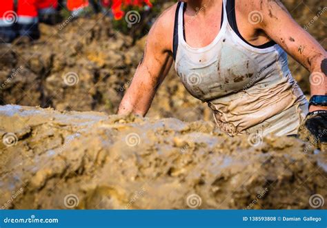 Mud Race Runners, Defeating Obstacles by Using Ropes. Editorial Stock ...