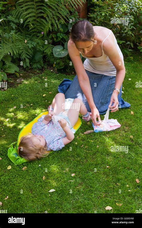 Mum mother parent carer changing nappies nappy change of baby toddler ...