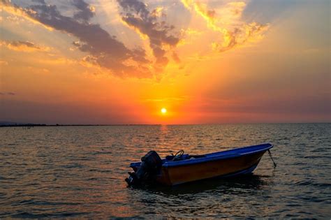 Premium Photo | Boat on the sea at sunset