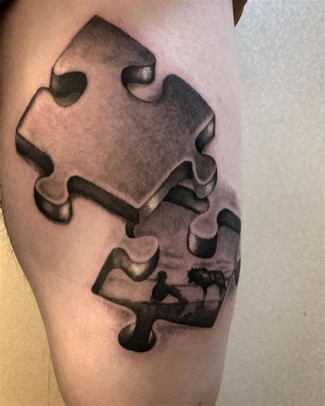 a piece of puzzle tattoo on the leg