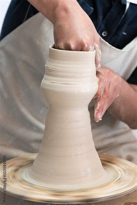 Potter sculpts from clay in a workshop of pots using ancient technology ...