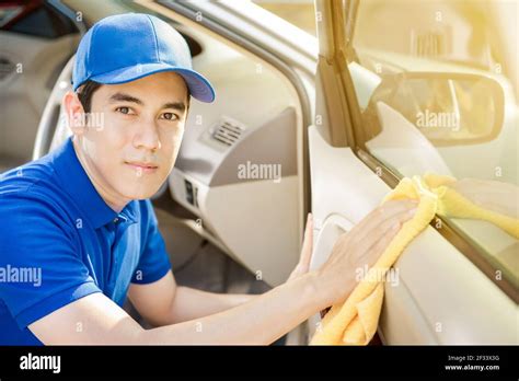 Auto service staff cleaning car door - car detailing and valeting concept Stock Photo - Alamy