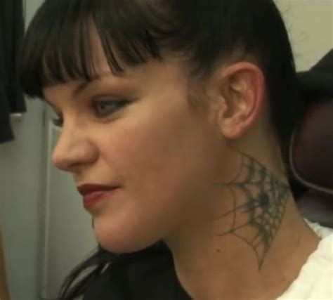 a woman with a spider web tattoo on her neck