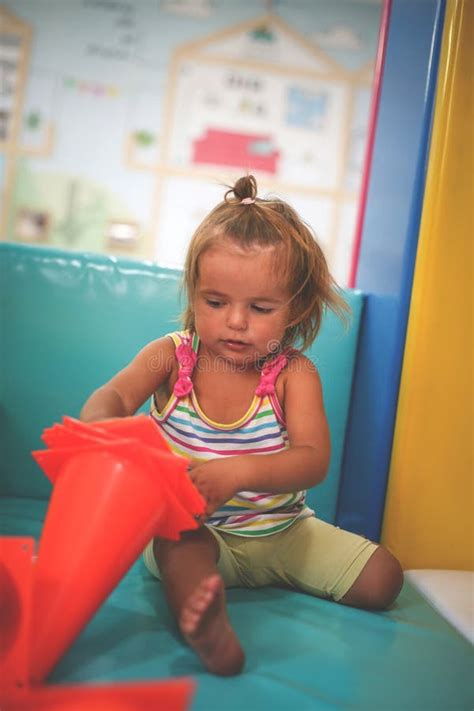 Little Girl Playing with Toys. Stock Photo - Image of holding, sitting ...