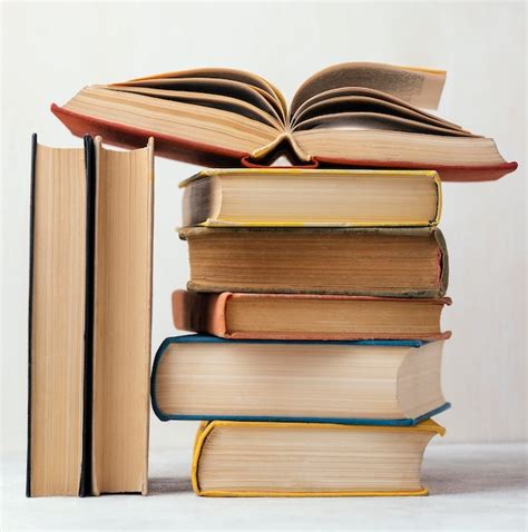 Free Photo | Front view of stack of books with one open