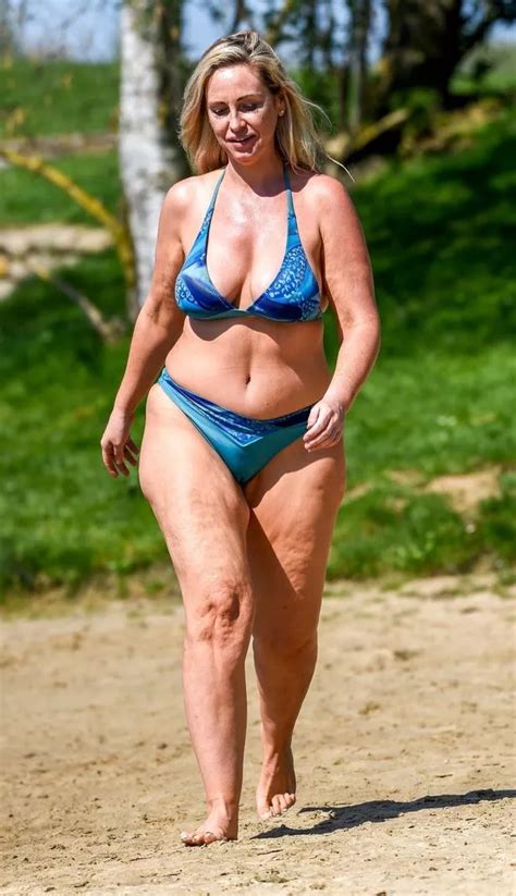 Josie Gibson tucks into crisps as she embraces fuller figure in blue bikini nearly two years ...