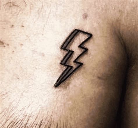 a man's chest with a lightning symbol tattoo on his left side ribcage