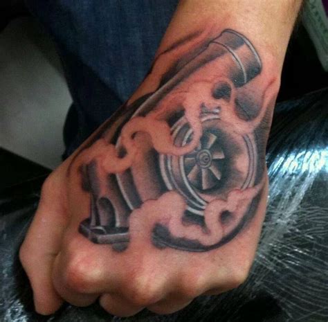 a man's hand with a tattoo on it that has an engine in the middle