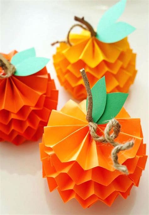 three paper pumpkins sitting on top of a table