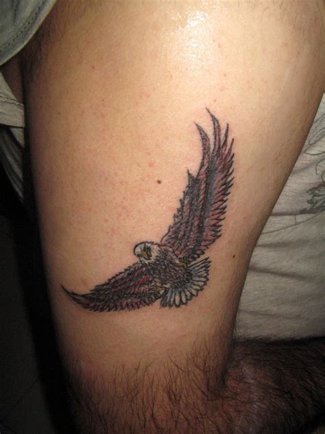 Colorful Flying Bald Eagle Tattoo On Thigh