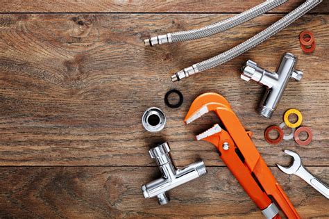 Set of plumbing tools on wooden table background. « FitzGerald & Sons ...