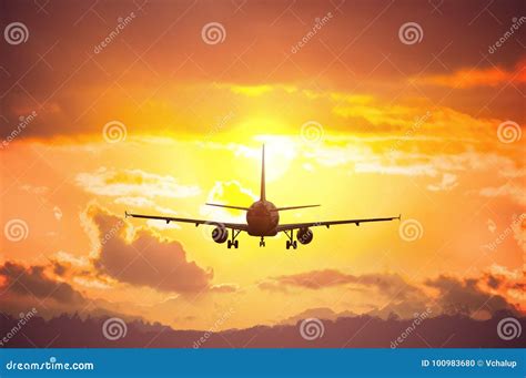 Silhouette of Airplane Flying in Sunset Stock Photo - Image of ...