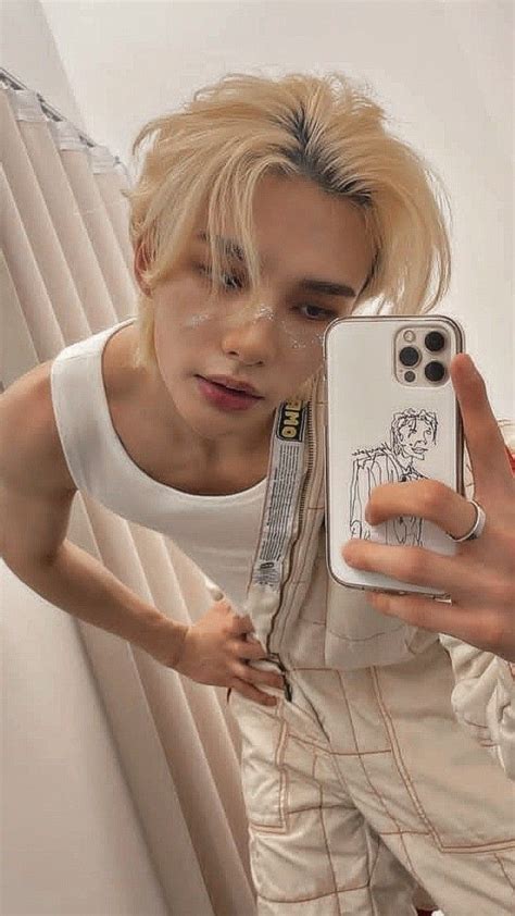 a person taking a selfie in front of a mirror with their cell phone up