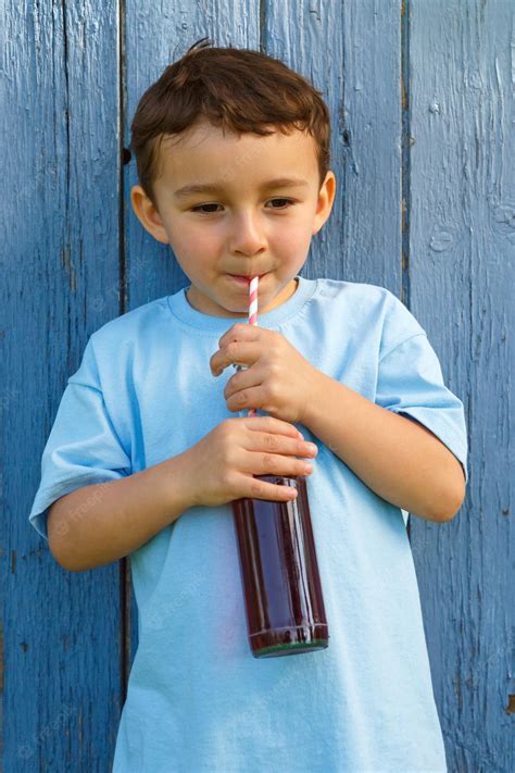 Premium Photo | Child kid little boy drinking cola lemonade drink ...