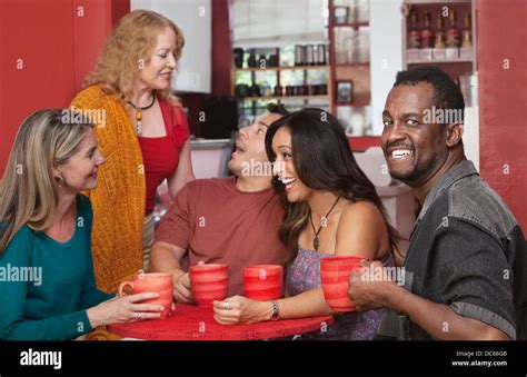 Joyful group mature friends sitting hi-res stock photography and images