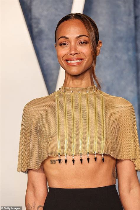 woman wearing  gold top  black skirt  spikes   chest
