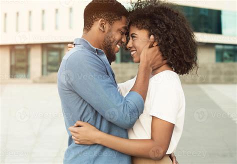 Never let me go. Couple enjoying date, walking in the city, side view