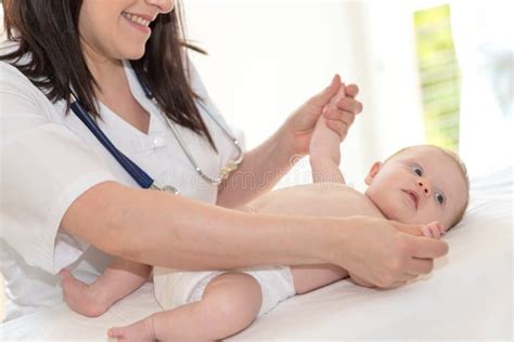pediatrician examining baby stock image image  smiling baby