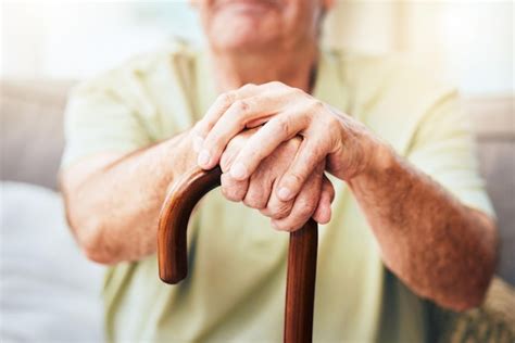 Premium Photo | Elderly man hands and walking stick for disability or ...