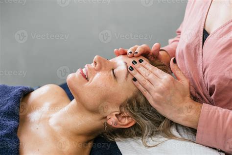 A woman getting a facial massage 59326821 Stock Photo at Vecteezy