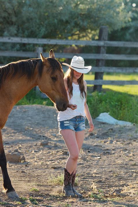 "Cowgirl Walking With Her Horse" by Stocksy Contributor "Tana Teel