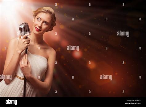 attractive female singer with microphone Stock Photo - Alamy