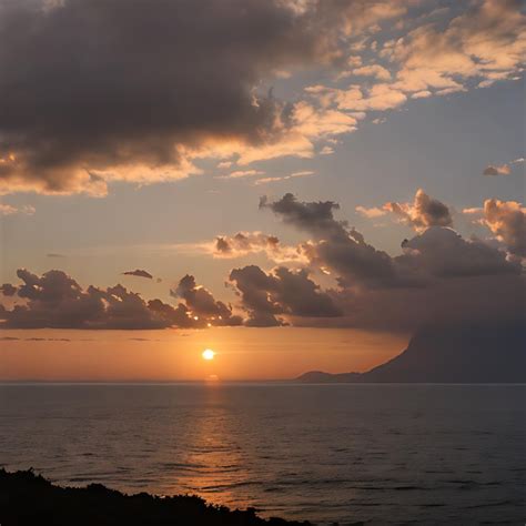 Premium Photo | A sunset over the ocean with a mountain in the background