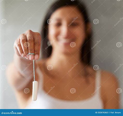 Ive Got One for You. a Young Woman Holding a Tampon at Home. Stock