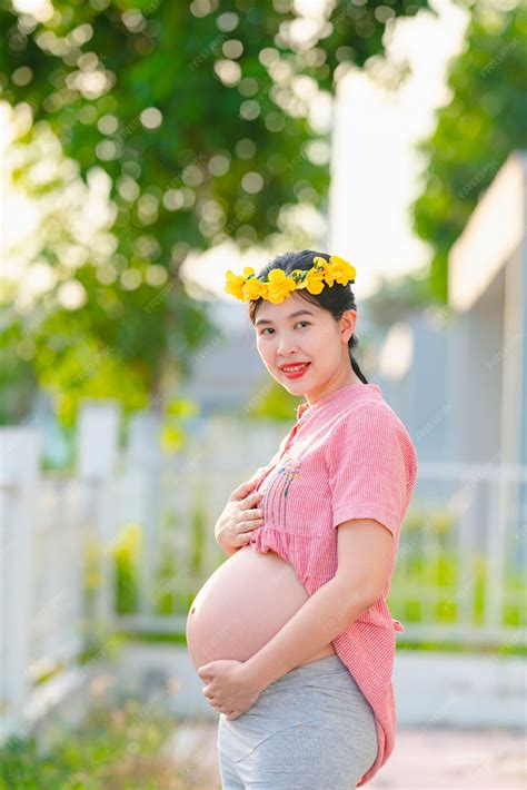 Premium Photo | Asian pregnant woman wearing a pink robe and smiling